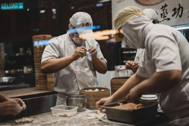 two man wrapping food